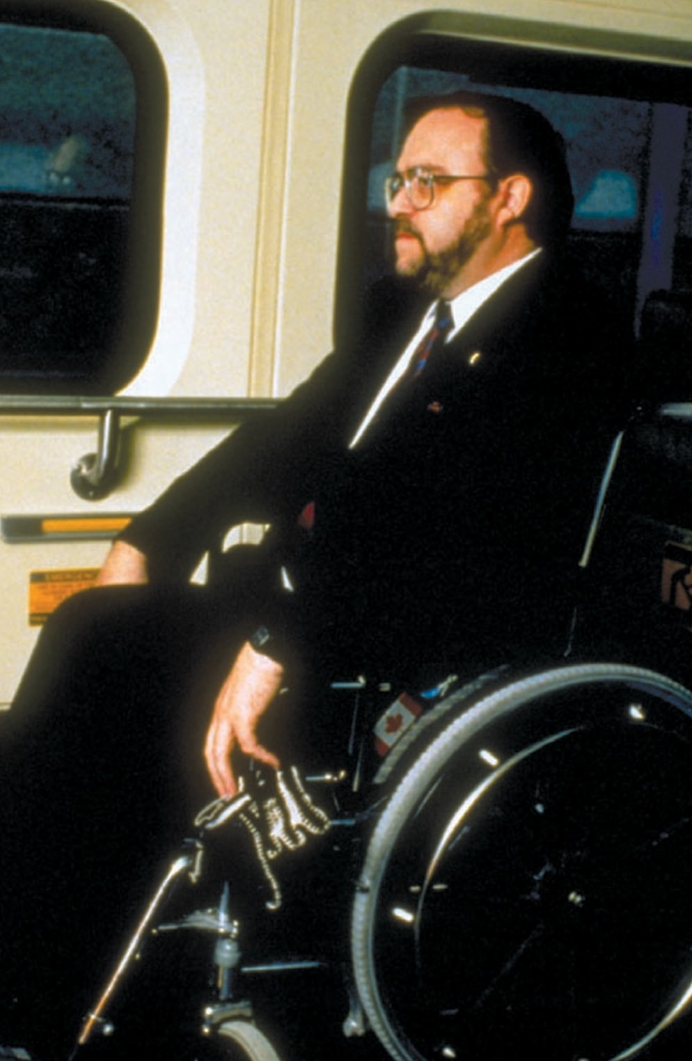 Disabled customer using wheelchair ramp to exit GO Train circa 1990s